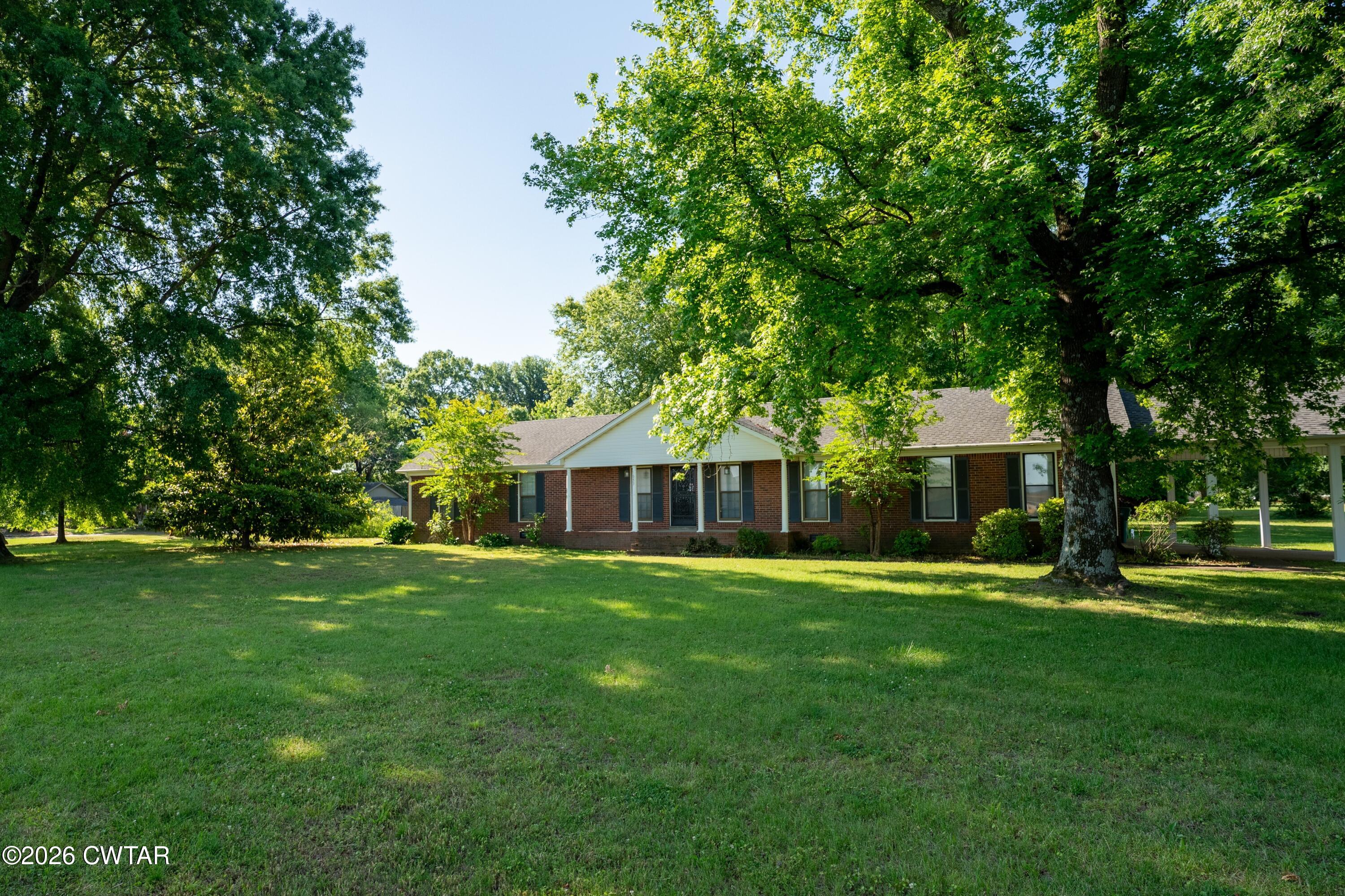 1053 Ashport Road Jackson, TN 38305 - Photo 8 of 42 a front view of house with yard and green space