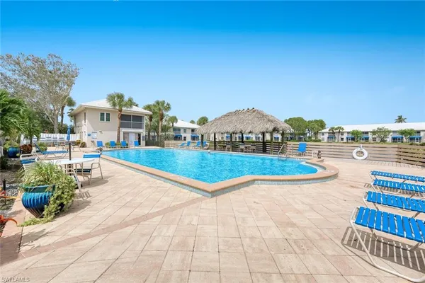 a view of swimming pool with outdoor seating and plants