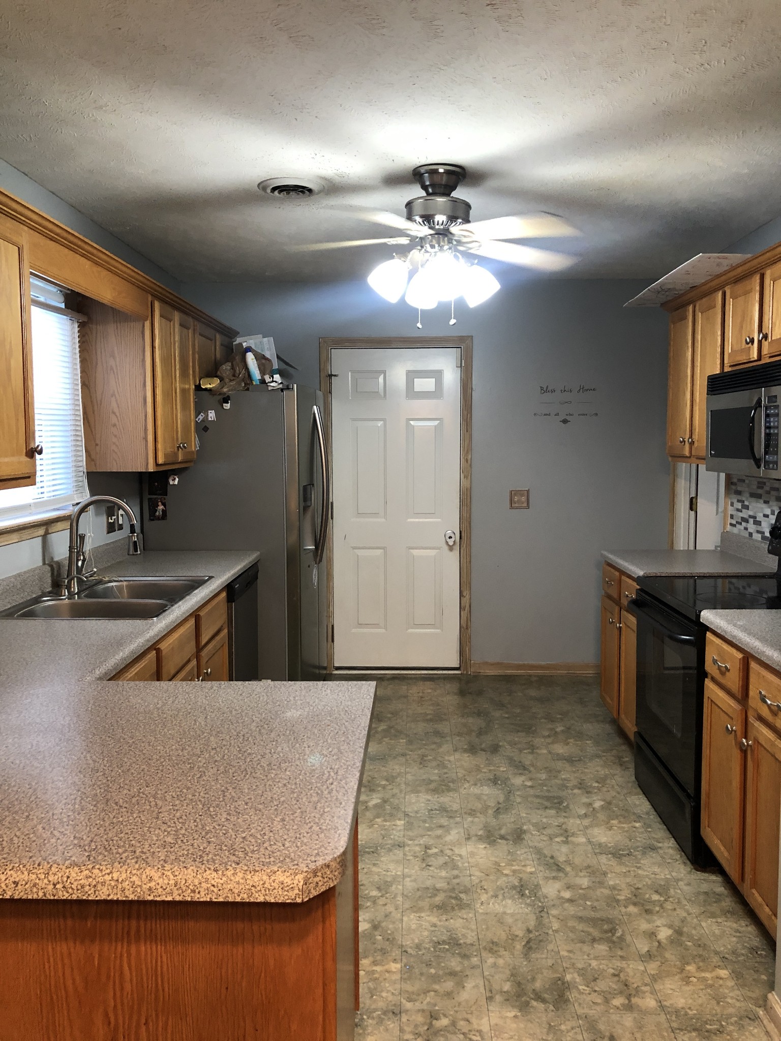 725 Crescent Road Murfreesboro, TN 37128 - Photo 8 of 16 a kitchen with kitchen island granite countertop a sink a counter top space appliances and cabinets