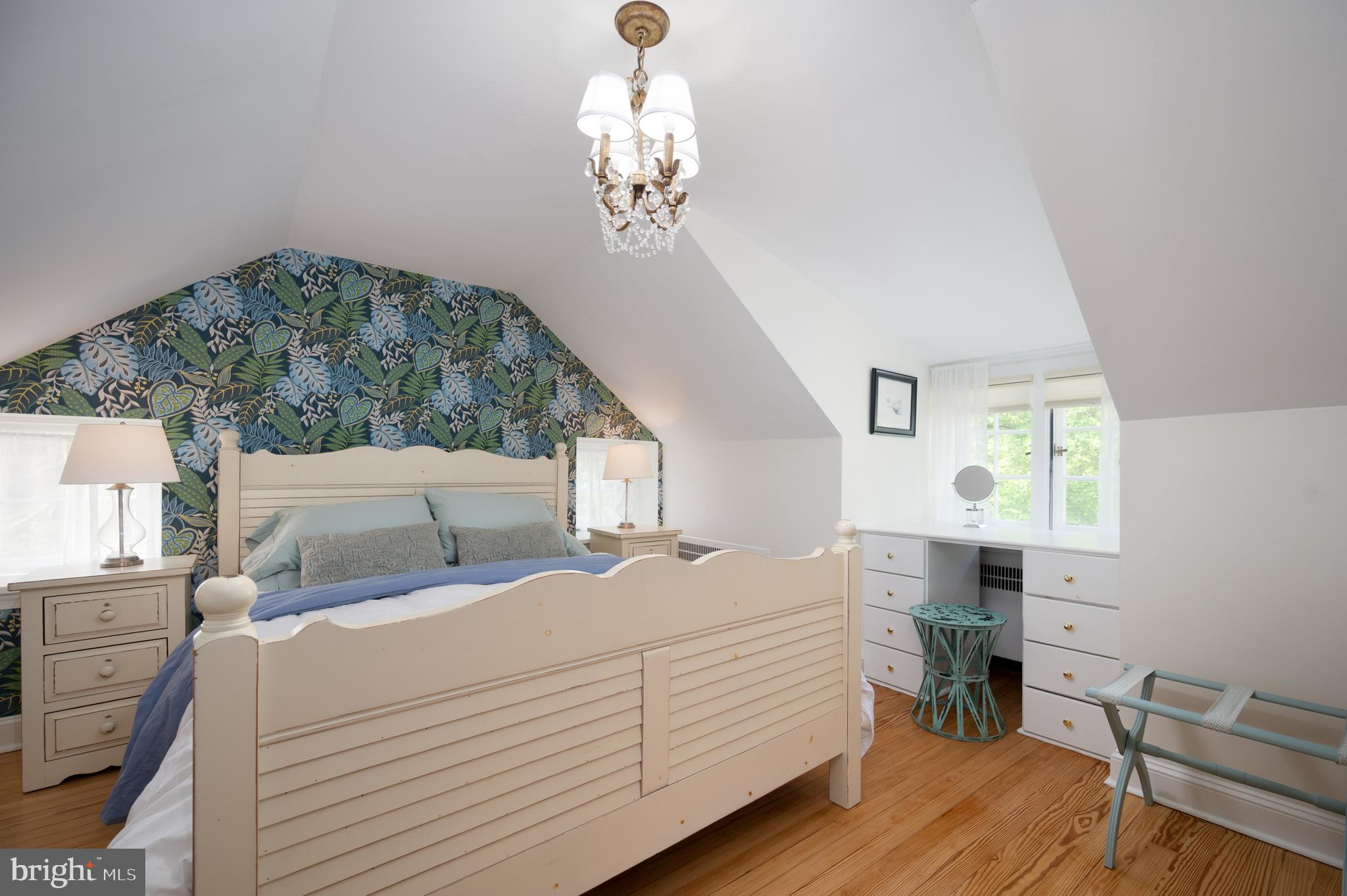 907 Overbrook Road Wilmington, DE 19807 - Photo 18 of 25 a bedroom with a bed and a chandelier