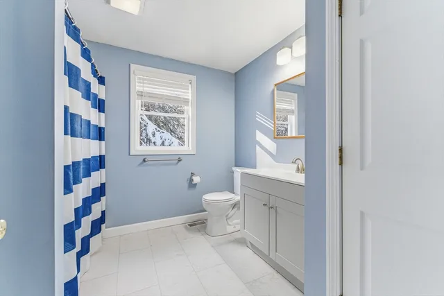 a spacious bathroom with a toilet and a shower