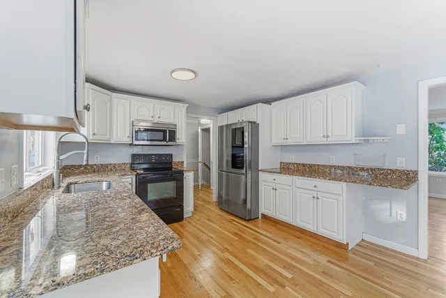 a kitchen with refrigerator and microwave
