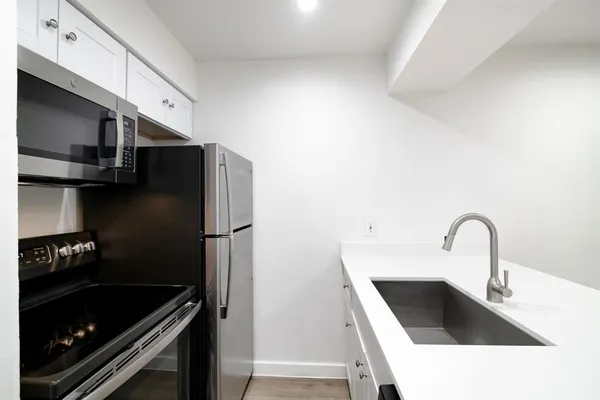 a kitchen with a sink and a refrigerator