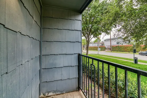 a view of a balcony with wooden fence