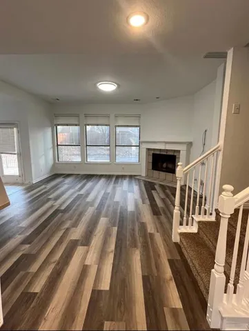 wooden floor in an empty room with a fireplace