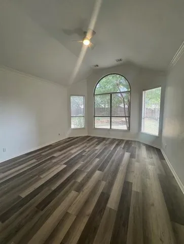 wooden floor in an empty room with a window