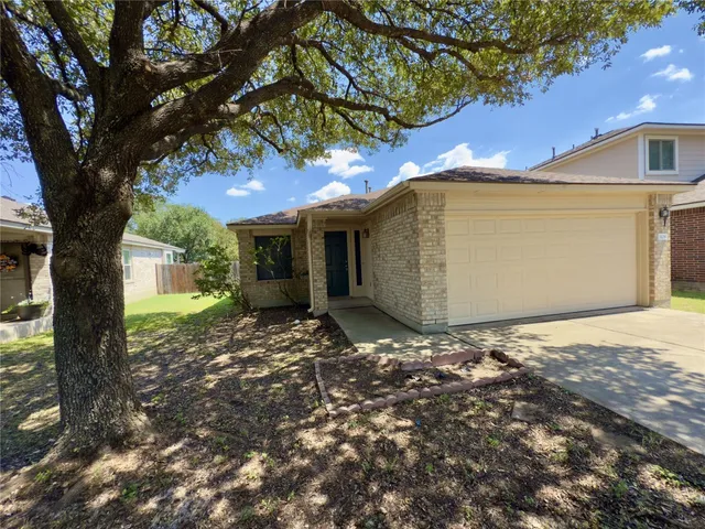 a view of a house with a tree