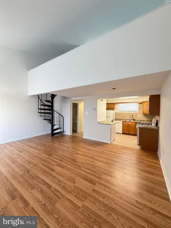 a kitchen with a stove sink and cabinets