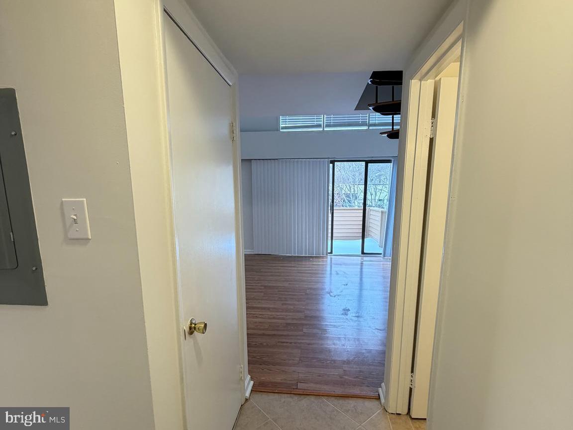 5485 Harpers Farm Road, Unit L5 Columbia, MD 21044 - Photo 10 of 17 a view of a hallway with wooden floor and entryway