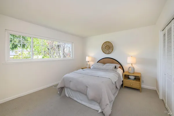 a bedroom with a bed and a mirror