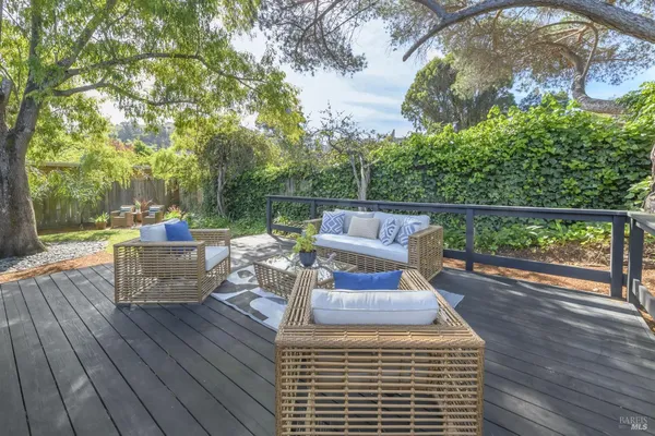 a backyard of a house with outdoor seating