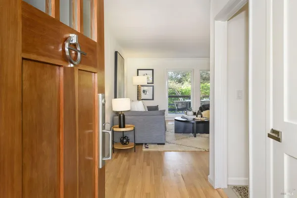 a view of a living room with furniture and hardwood floor