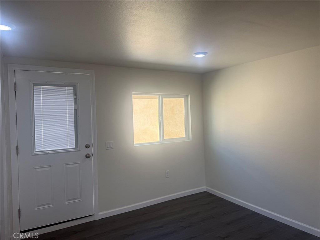 10337 Mull Avenue Riverside, CA 92505 - Photo 16 of 28 an empty room with wooden floor and windows