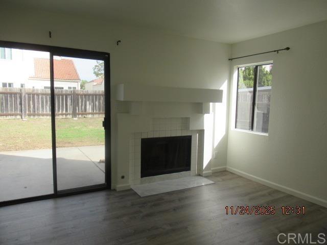 935 Redbud Road Chula Vista, CA 91910 - Photo 3 of 8 a view of an empty room with wooden floor and a window