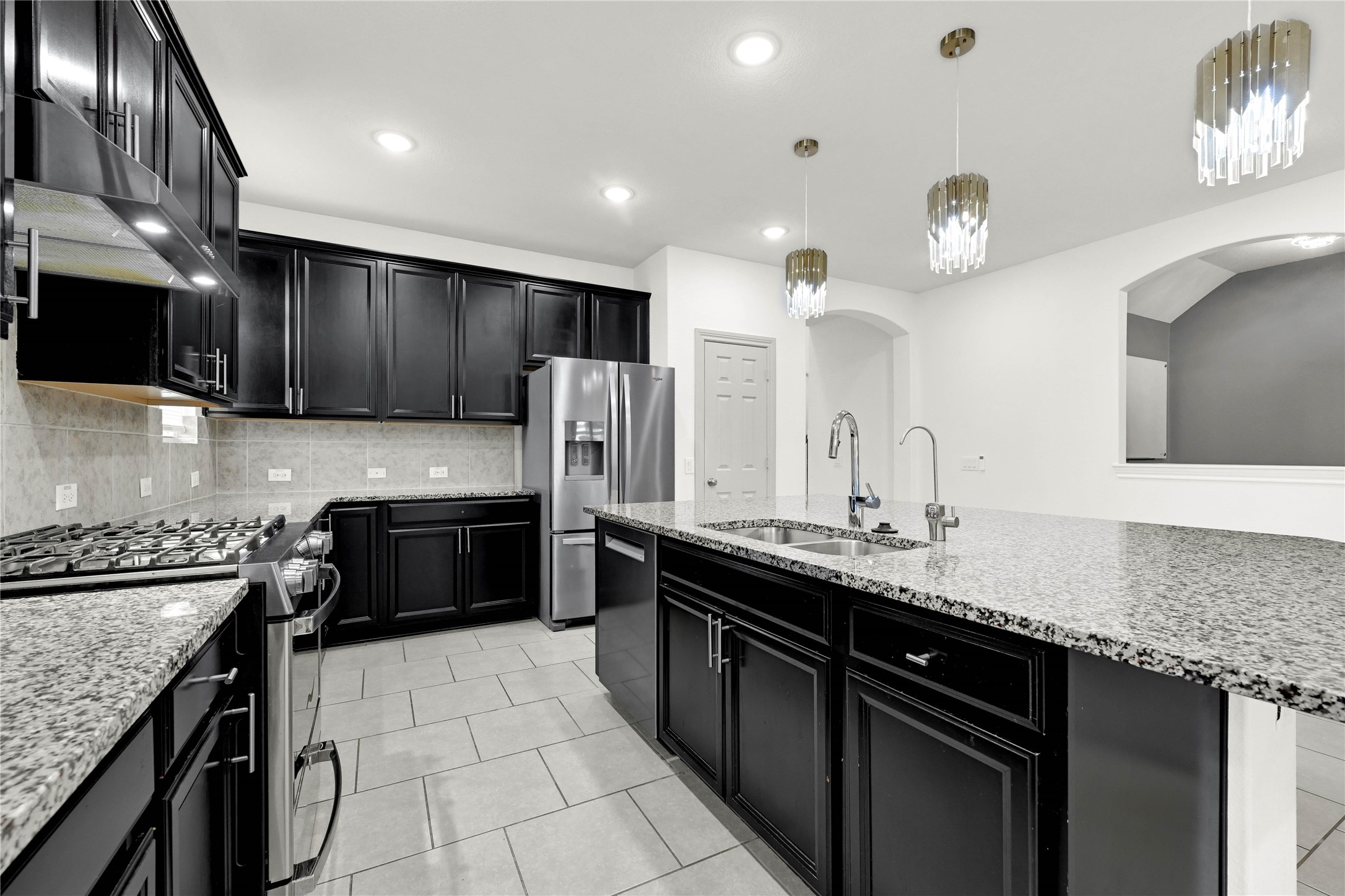 17802 Pepper Root Drive Spring, TX 77379 - Photo 13 of 34 a kitchen with a sink a stove and cabinets