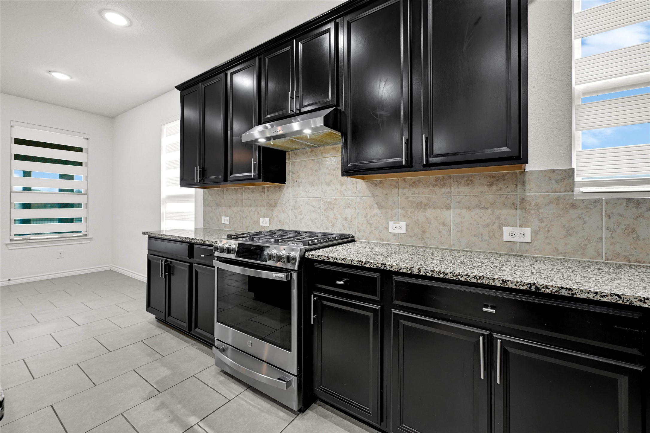 17802 Pepper Root Drive Spring, TX 77379 - Photo 14 of 34 a kitchen with granite countertop stainless steel appliances and wooden cabinets