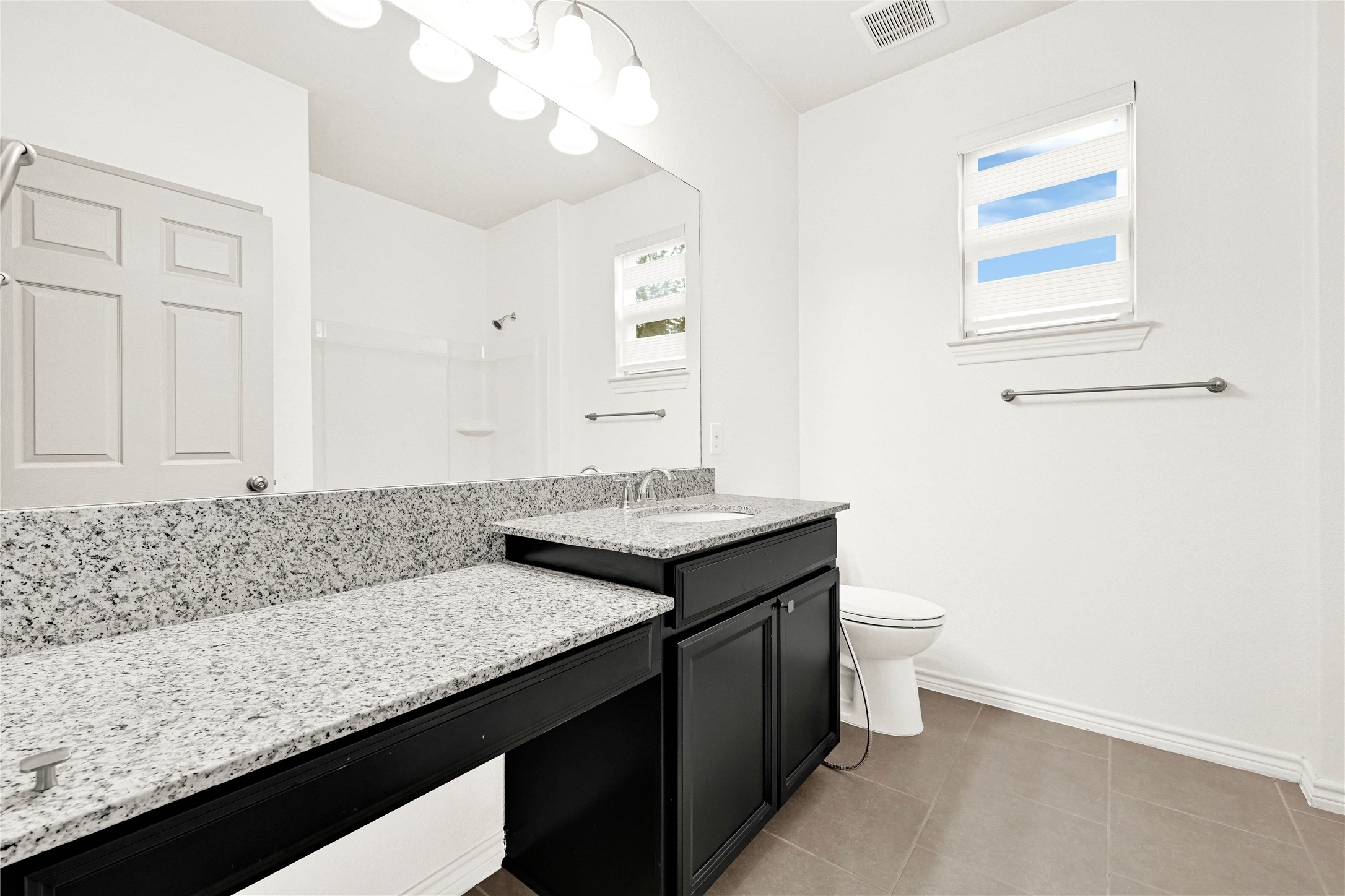 17802 Pepper Root Drive Spring, TX 77379 - Photo 21 of 34 a bathroom with a granite countertop sink a toilet and a mirror