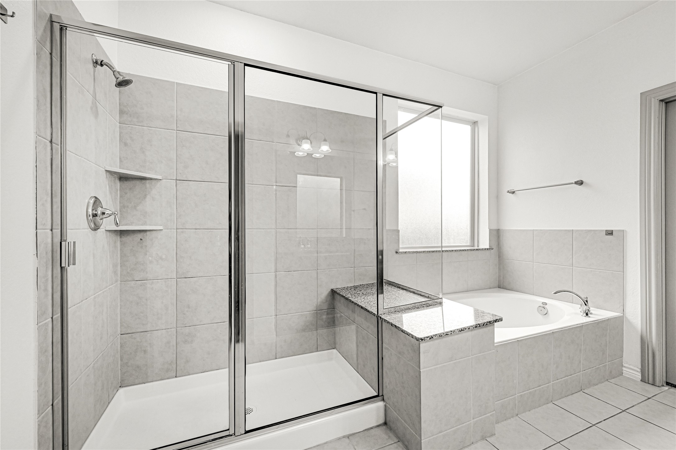 17802 Pepper Root Drive Spring, TX 77379 - Photo 27 of 34 a bathroom with a tub a sink and a glass door shower