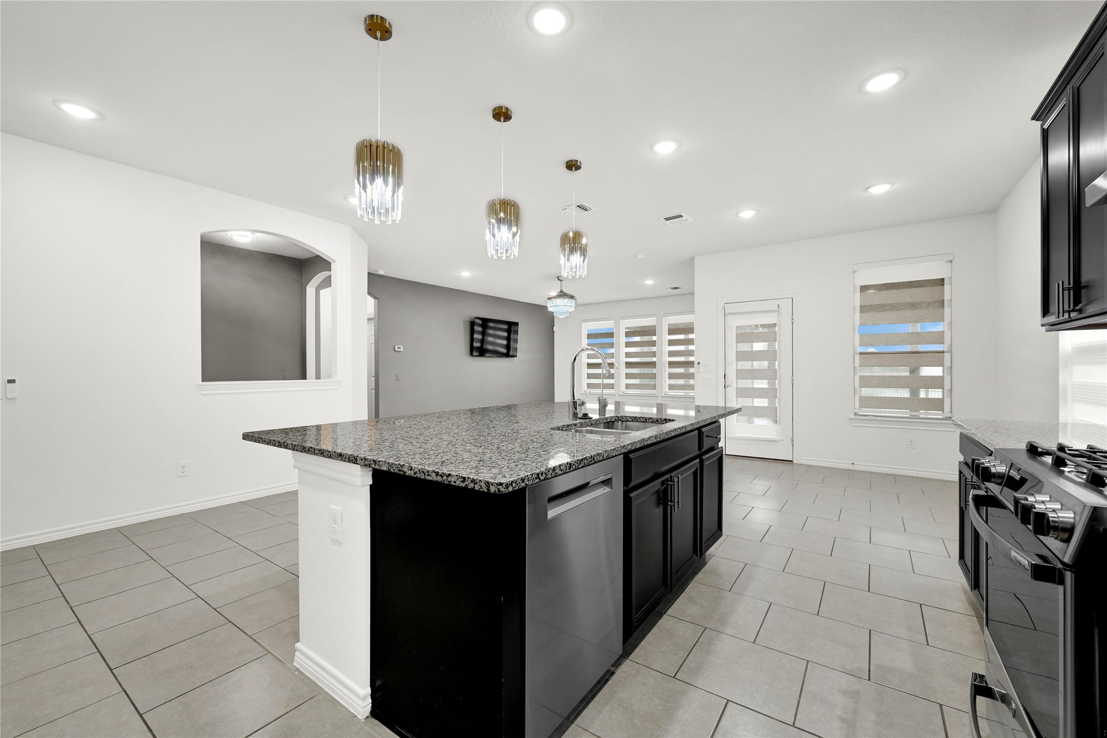 17802 Pepper Root Drive Spring, TX 77379 - Photo 9 of 34 a kitchen with granite countertop a sink and a stove