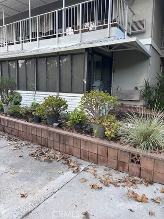 a view of a house with a wooden fence