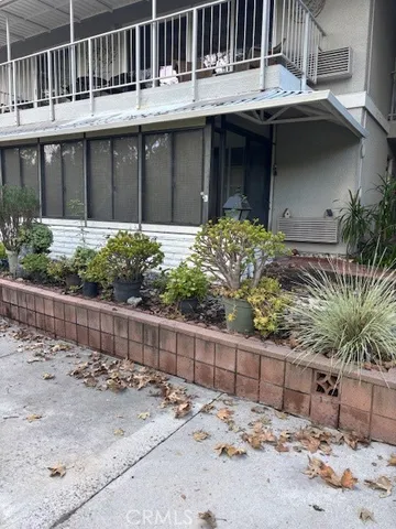a view of a house with a wooden fence