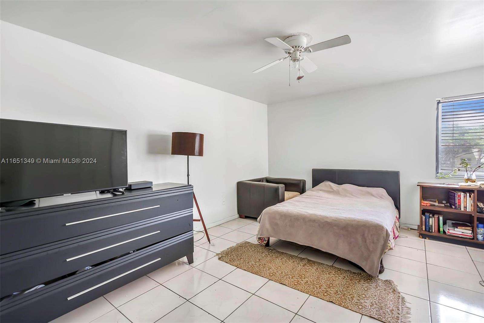 9823 Southwest 138th Avenue, Unit FC2L Miami, FL 33186 - Photo 11 of 28 a bedroom with bed and window