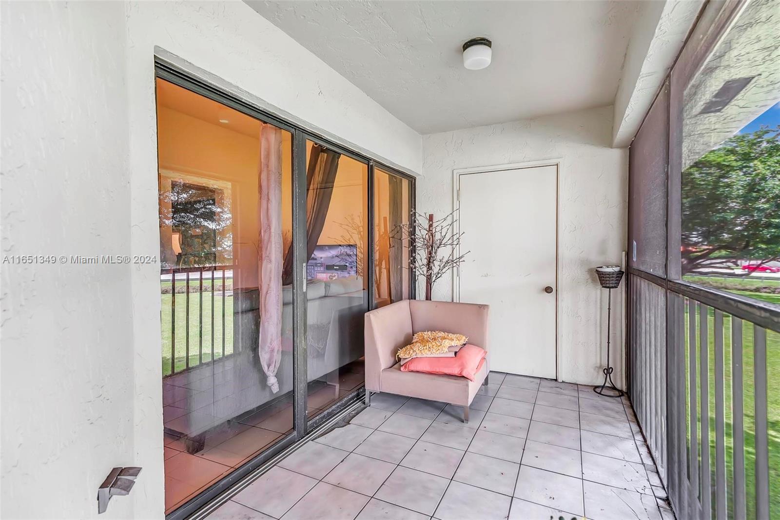 9823 Southwest 138th Avenue, Unit FC2L Miami, FL 33186 - Photo 13 of 28 a living room with furniture and a gate