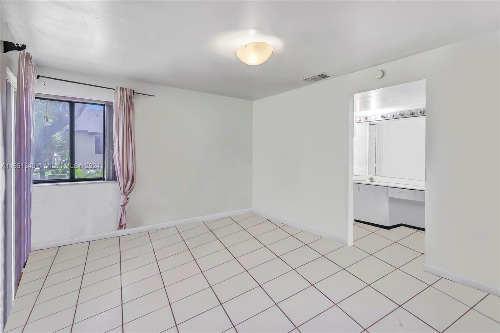 9823 Southwest 138th Avenue, Unit FC2L Miami, FL 33186 - Photo 17 of 28 a view of an empty room and window