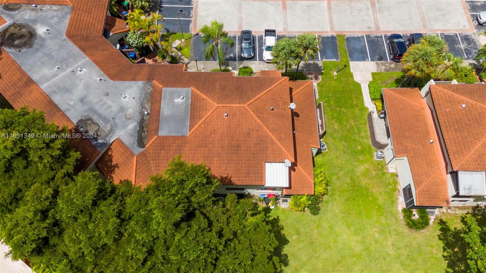 9823 Southwest 138th Avenue, Unit FC2L Miami, FL 33186 - Photo 23 of 28 an aerial view of a house with swimming pool and large trees