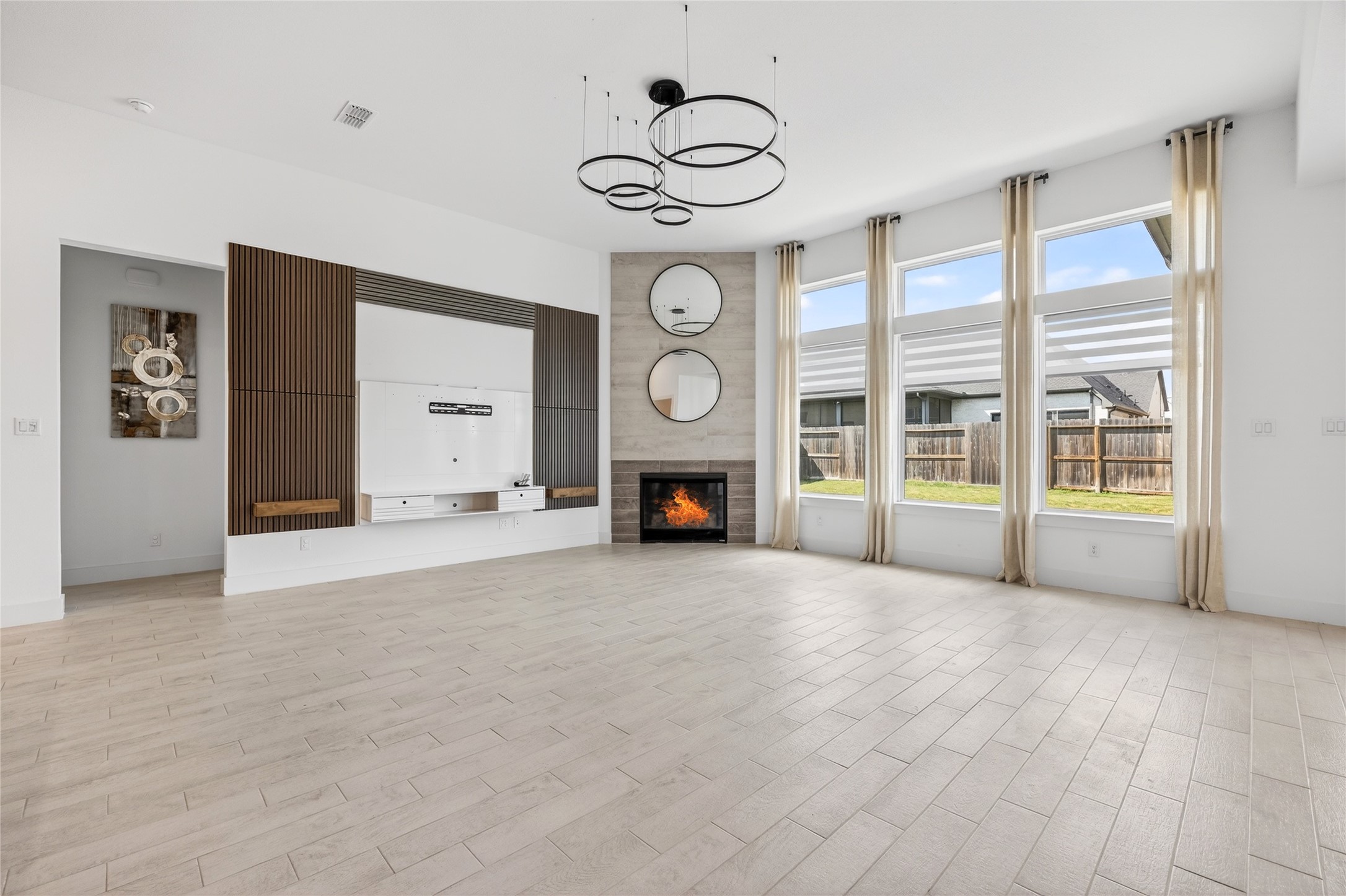 32018 Crested Knl Court Fulshear, TX 77441 - Photo 12 of 50 a view of an empty room with a fireplace and a window