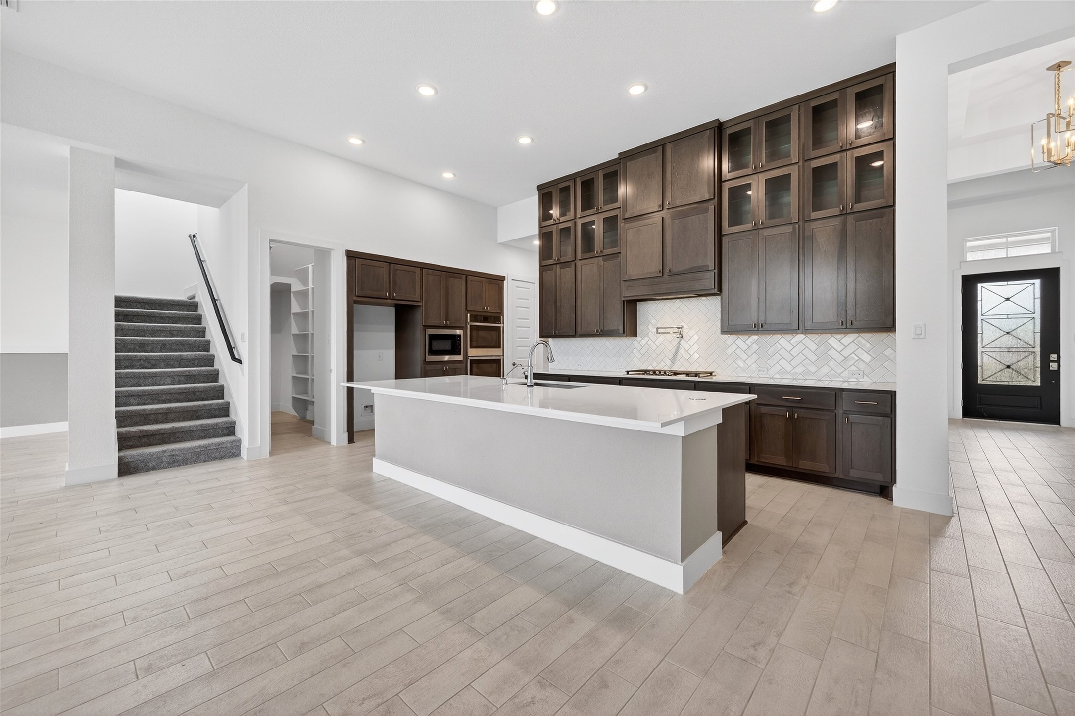 32018 Crested Knl Court Fulshear, TX 77441 - Photo 15 of 50 a large kitchen with stainless steel appliances kitchen island granite countertop a stove a sink and a refrigerator