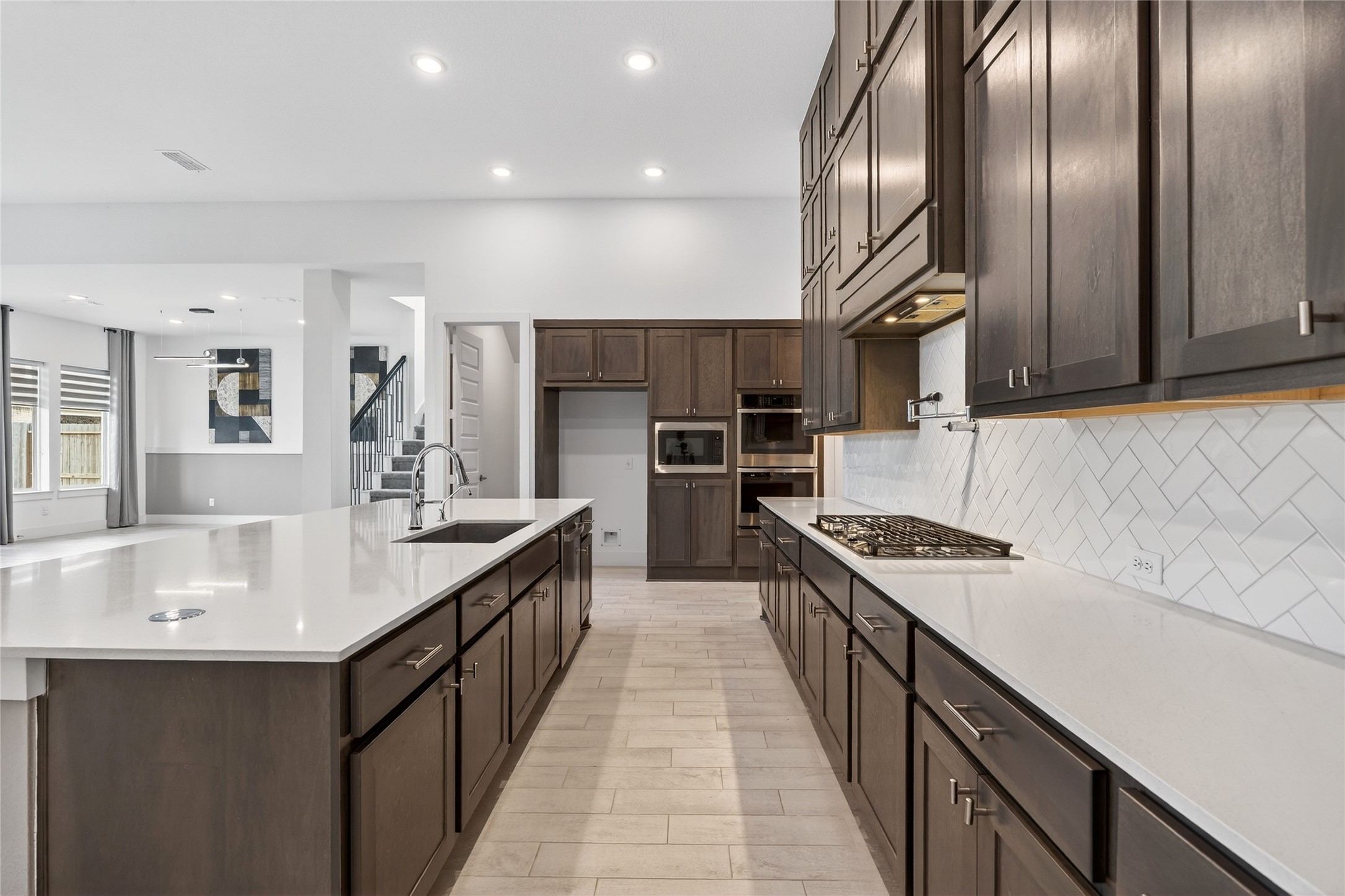 32018 Crested Knl Court Fulshear, TX 77441 - Photo 19 of 50 a kitchen with stainless steel appliances granite countertop a sink a stove and a refrigerator