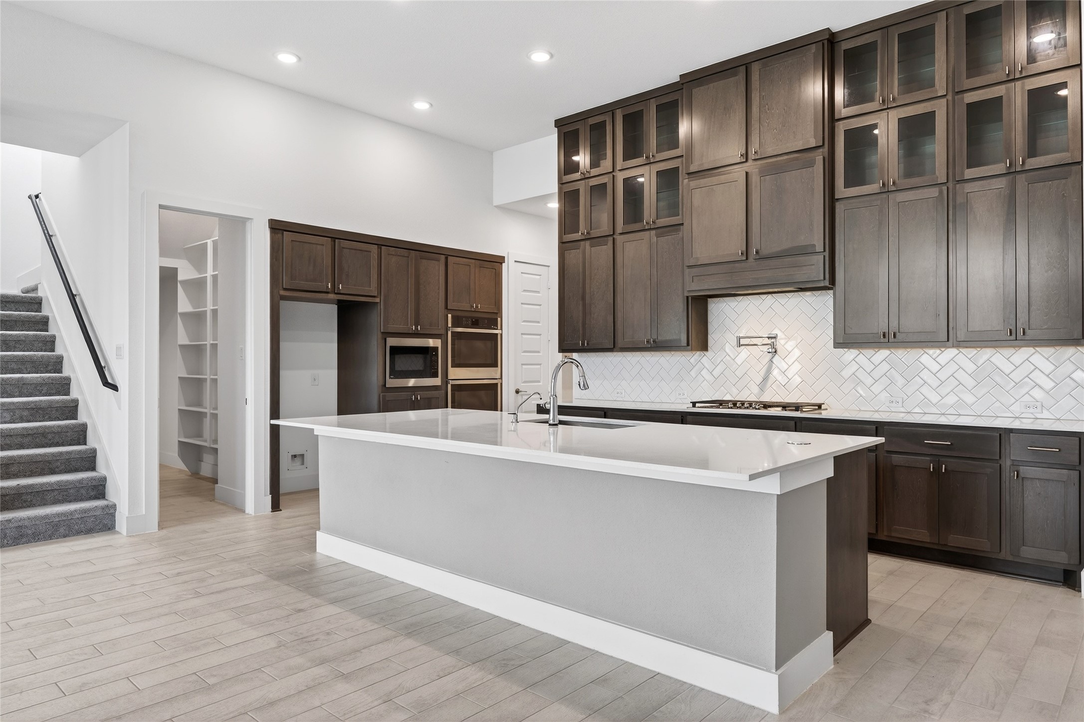 32018 Crested Knl Court Fulshear, TX 77441 - Photo 20 of 50 a kitchen with stainless steel appliances granite countertop a refrigerator and a stove top oven