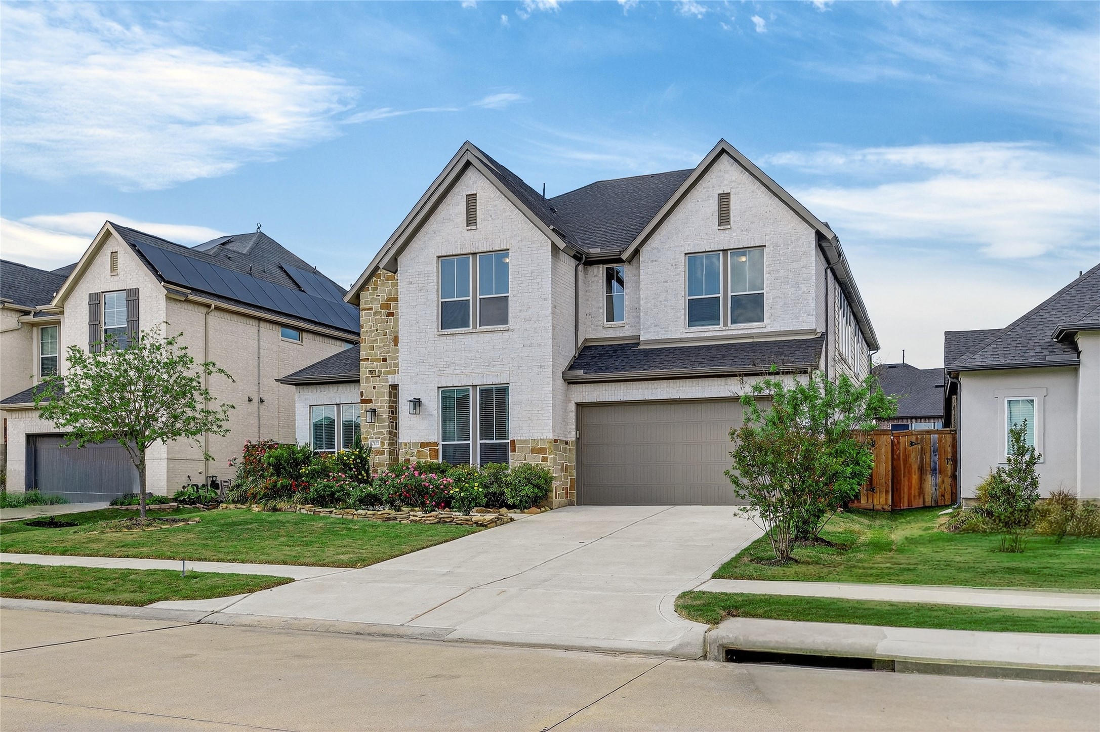 32018 Crested Knl Court Fulshear, TX 77441 - Photo 2 of 50 a front view of a house with a yard and garage
