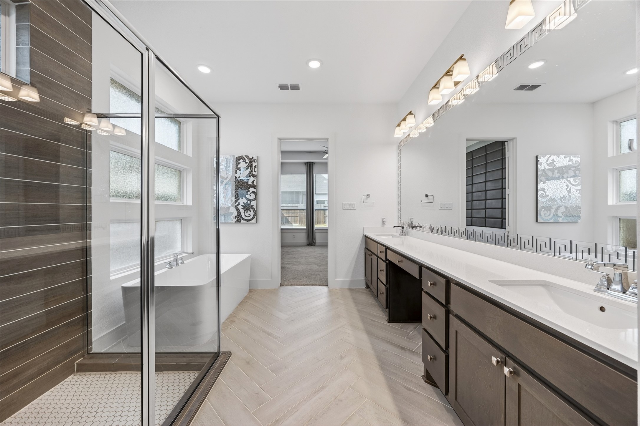 32018 Crested Knl Court Fulshear, TX 77441 - Photo 24 of 50 a spacious bathroom with a double vanity sink a large mirror and shower