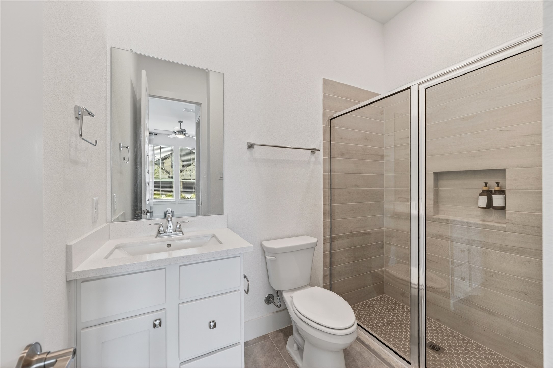 32018 Crested Knl Court Fulshear, TX 77441 - Photo 34 of 50 a bathroom with a sink a mirror a toilet and shower