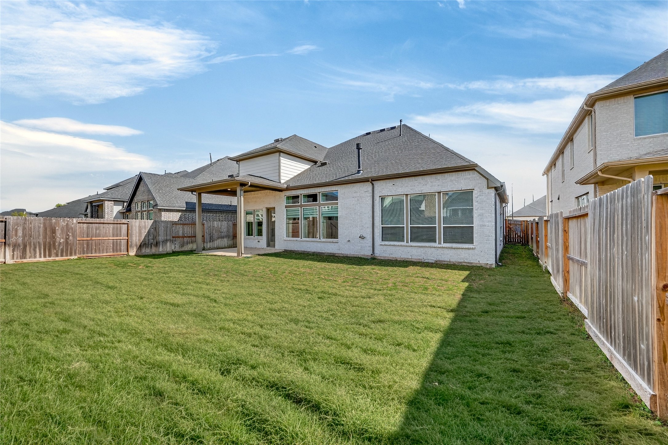 32018 Crested Knl Court Fulshear, TX 77441 - Photo 49 of 50 a view of a big house with a big yard and large trees