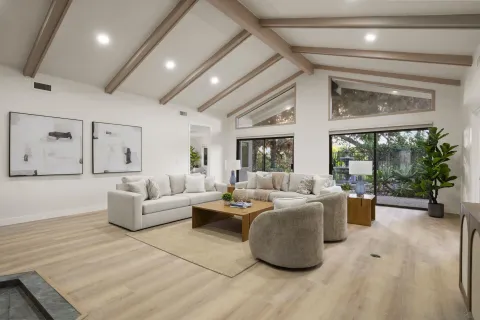 a living room with furniture and a large window
