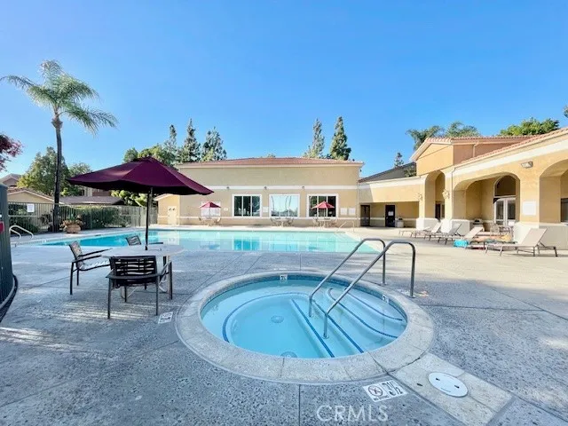 a view of a house with swimming pool and sitting area