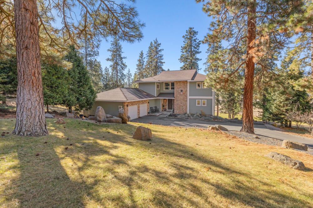 11750 Merganser Road Klamath Falls, OR 97601 - Photo 2 of 66 a front view of a house with a yard covered with snow and trees