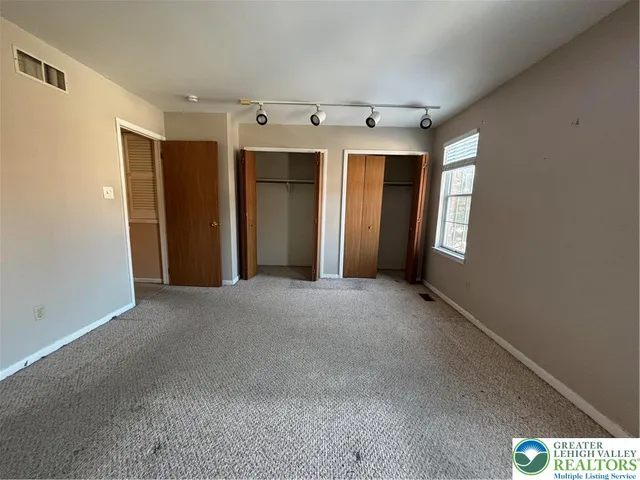 a view of a hallway with windows and cabinet