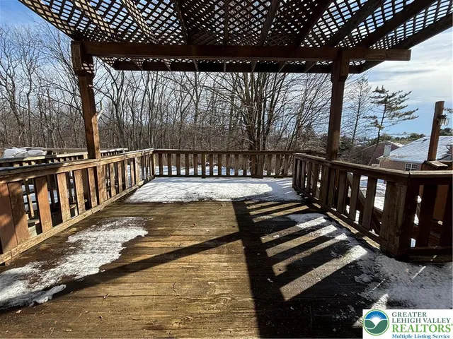 a view of a roof deck with wooden floor and fence