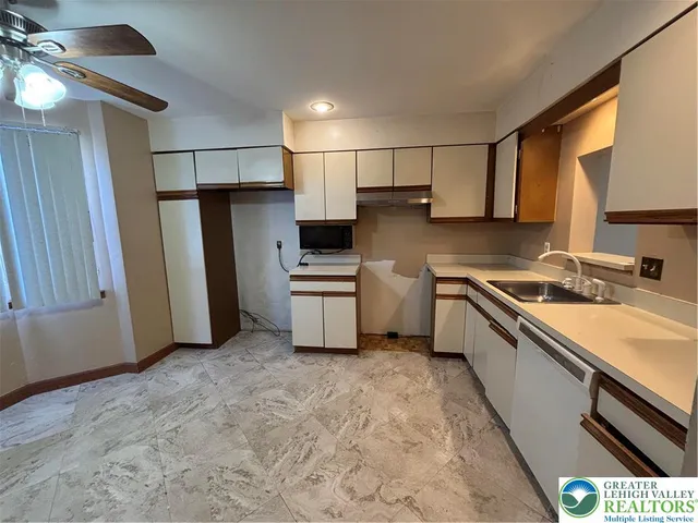 a kitchen with stainless steel appliances a refrigerator sink and microwave