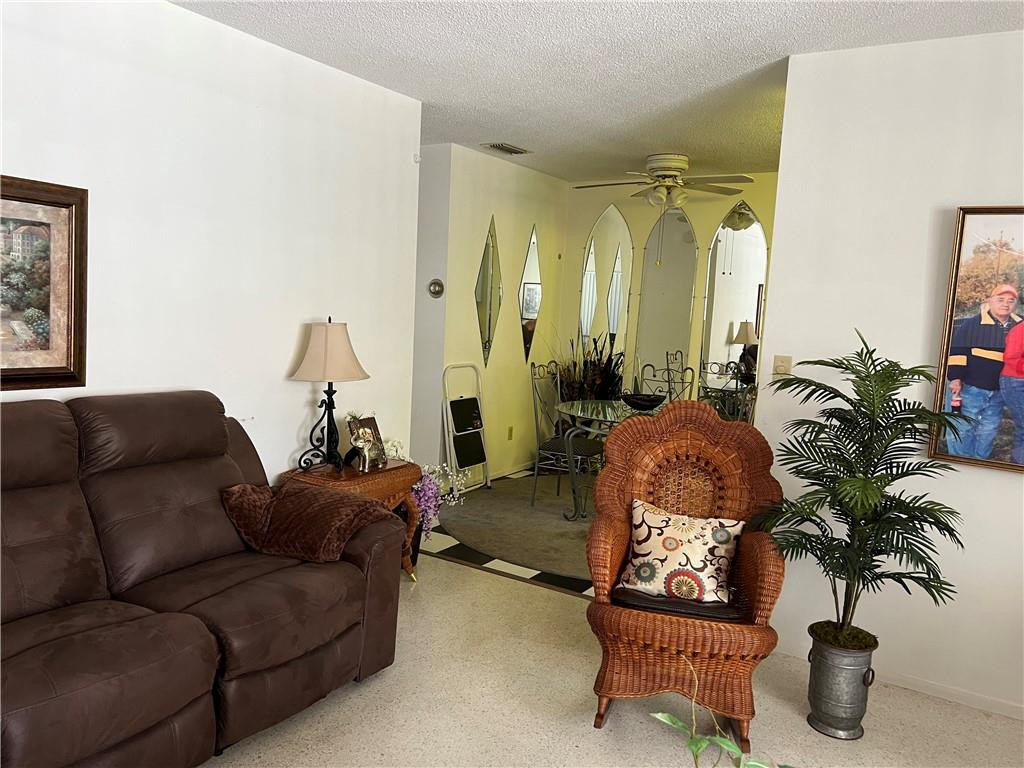 1833 Monroe Street, Unit 17 Hollywood, FL 33020 - Photo 5 of 9 a living room with furniture and a potted plant