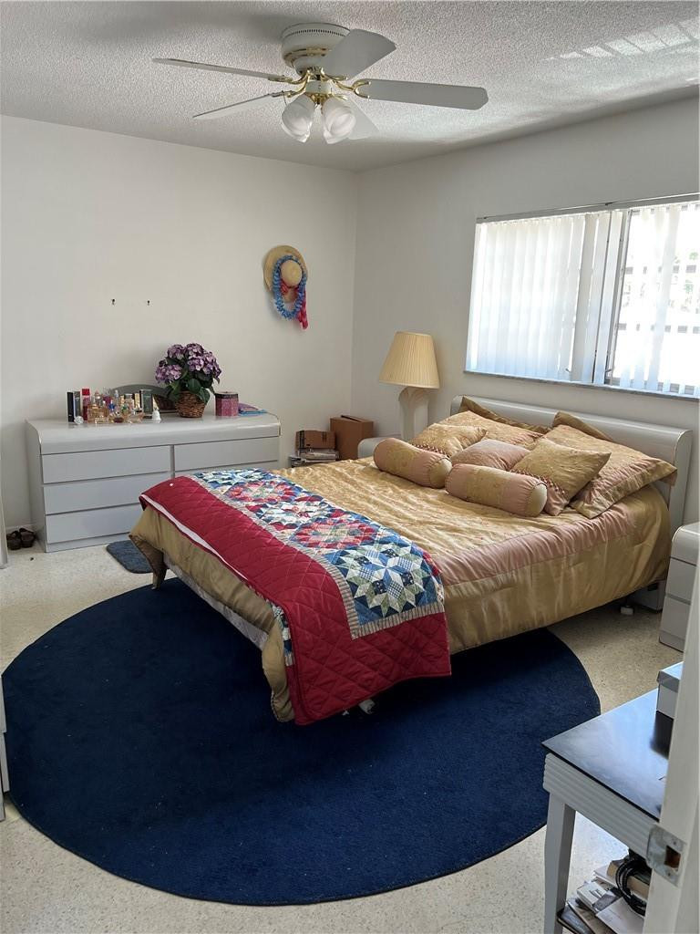 1833 Monroe Street, Unit 17 Hollywood, FL 33020 - Photo 6 of 9 a bedroom with a bed and a chandelier