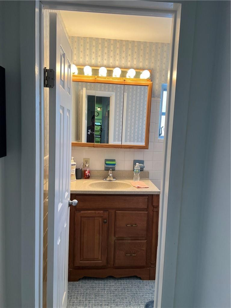 1833 Monroe Street, Unit 17 Hollywood, FL 33020 - Photo 7 of 9 a bathroom with a sink and a mirror