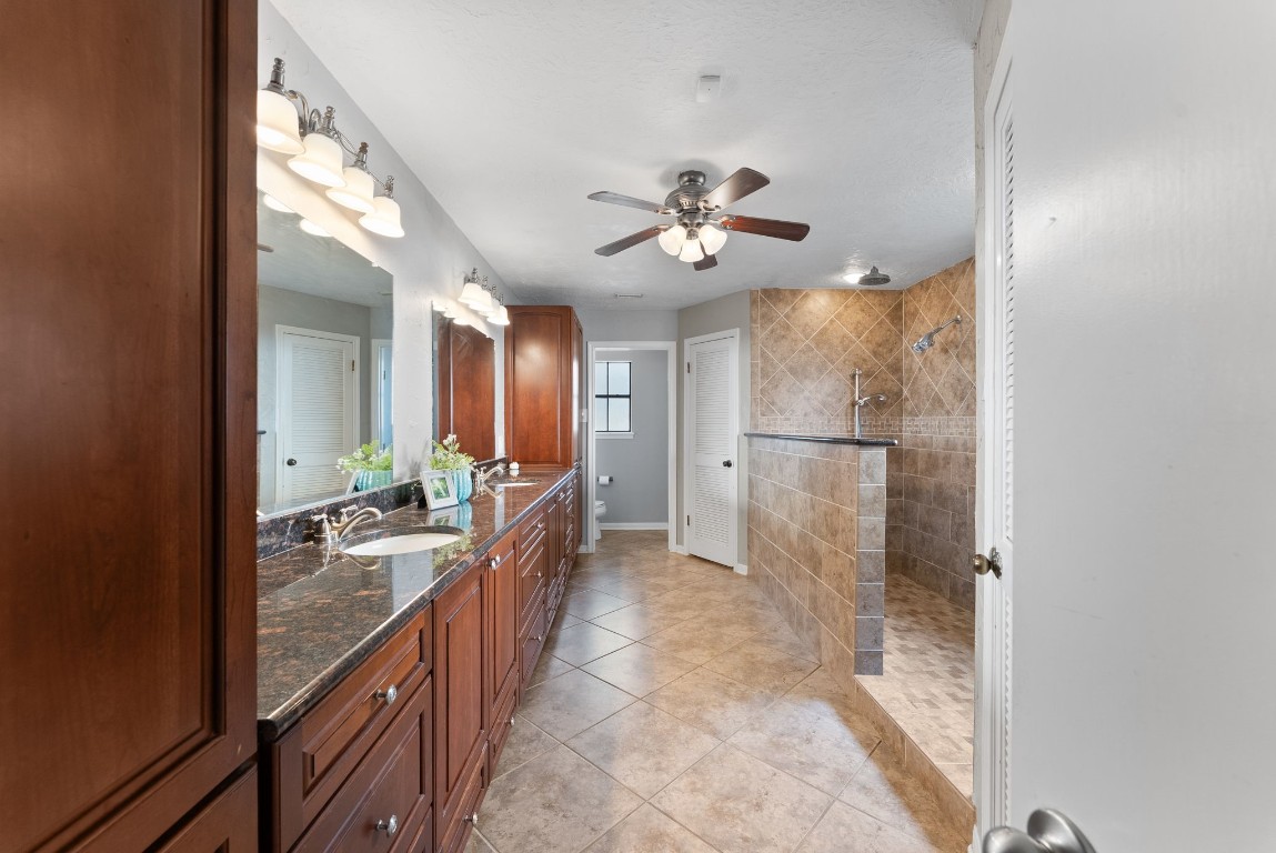 16927 Windypine Drive Spring, TX 77379 - Photo 18 of 46 a bathroom with a double vanity sink a mirror and shower