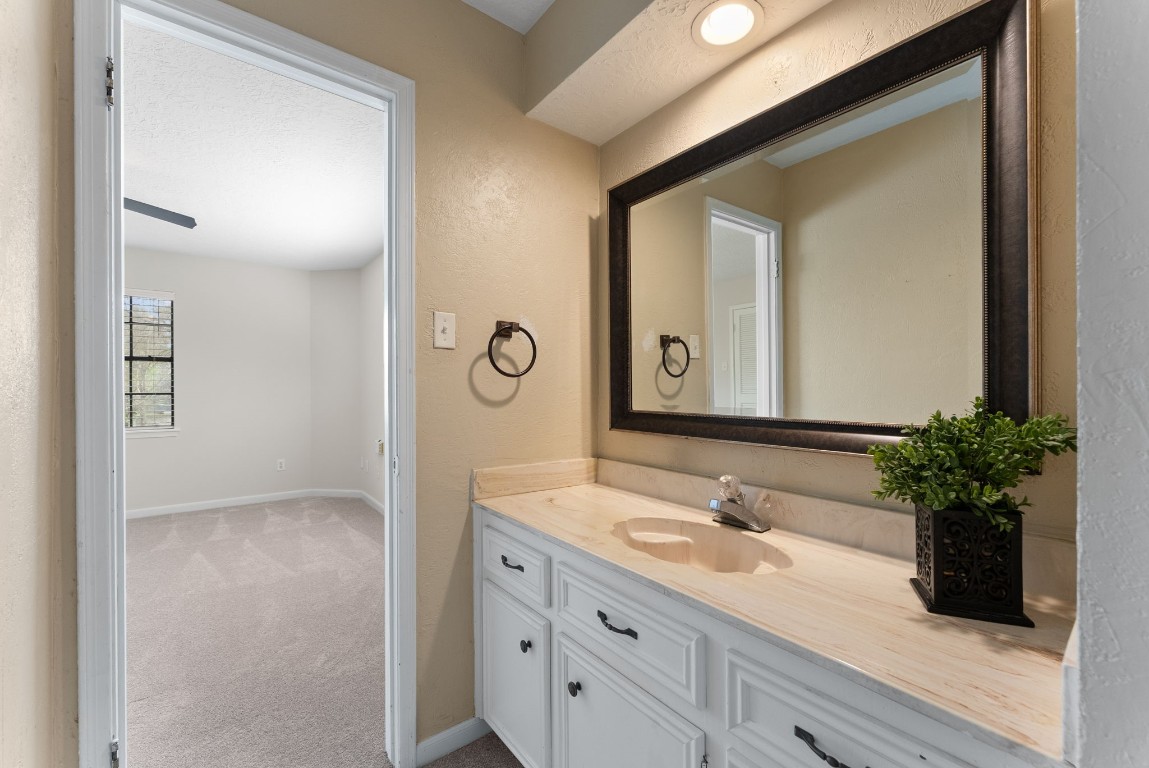 16927 Windypine Drive Spring, TX 77379 - Photo 25 of 46 a bathroom with a granite countertop sink a large mirror and a potted plant