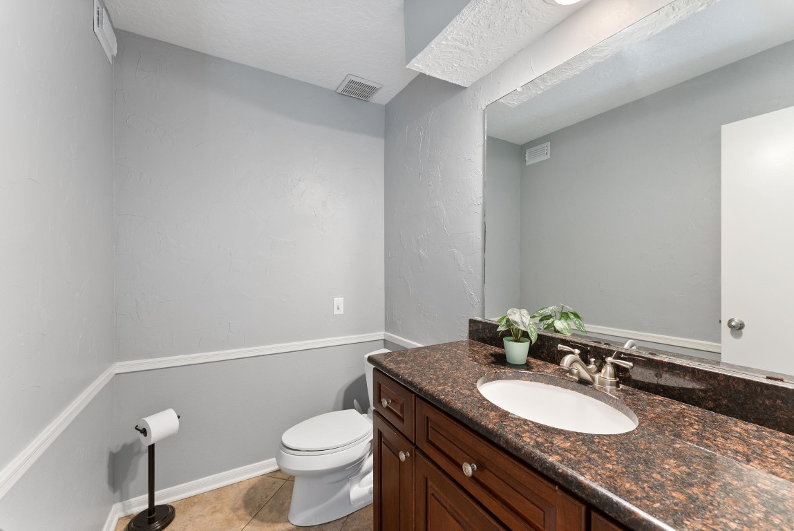 16927 Windypine Drive Spring, TX 77379 - Photo 28 of 46 a bathroom with a granite countertop sink a large mirror and toilet