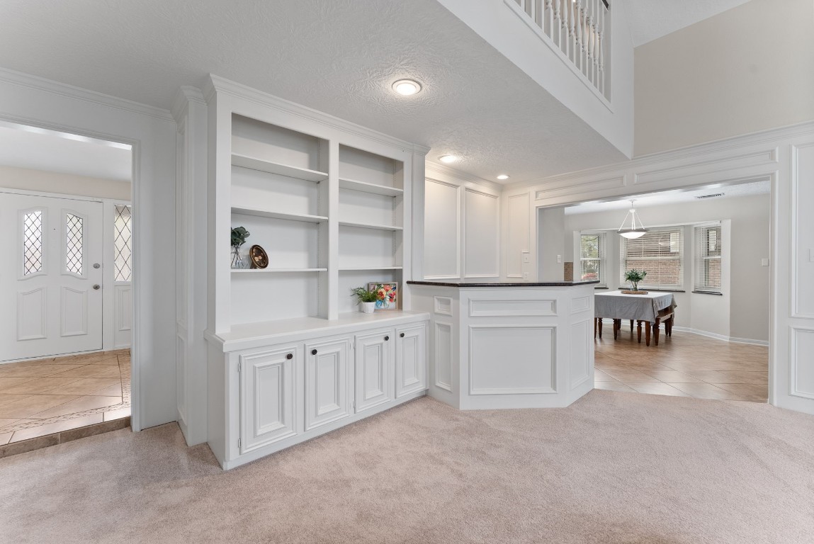 16927 Windypine Drive Spring, TX 77379 - Photo 10 of 46 a open kitchen with white cabinets and chairs